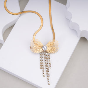 Gold butterfly pendant necklace with pearl center and dangling rhinestone chains on white background
