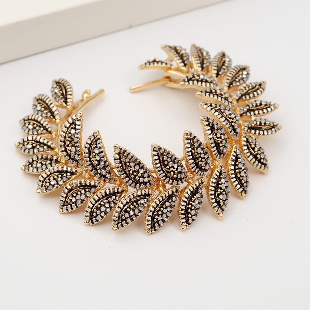 Gold leaf-shaped ladies hair accessory with embedded crystals from Maniyar Bazaar