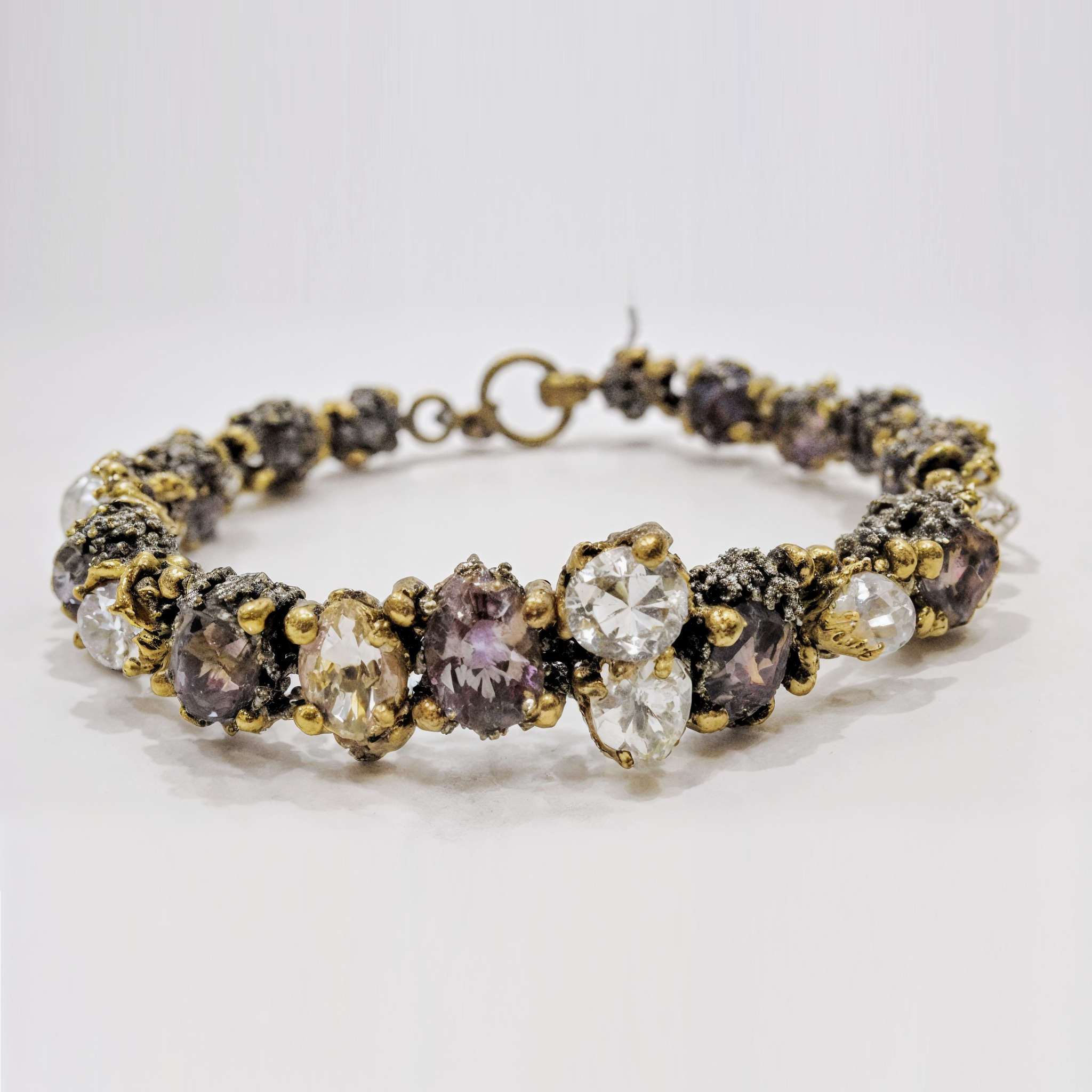Gold-tone bracelet with clear and purple gemstone clusters, vintage-style fashion jewelry